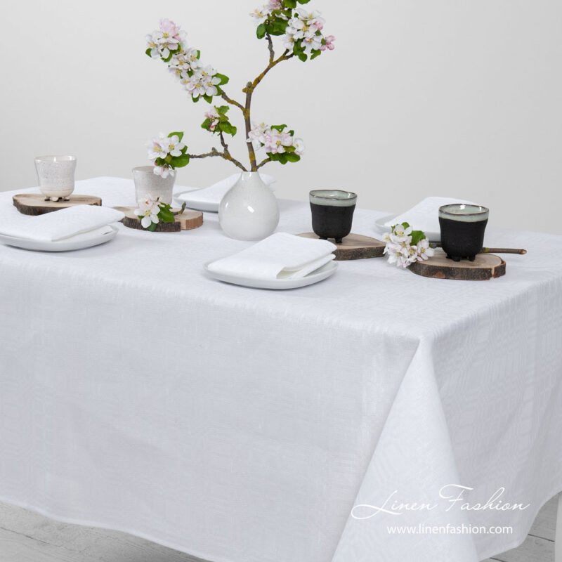 White patterned linen tablecloth, simply hemmed