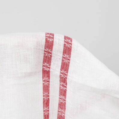 White linen fabric with red lines close up detail