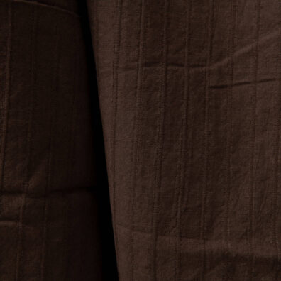 Dark brown washed linen cotton fabric close up detail