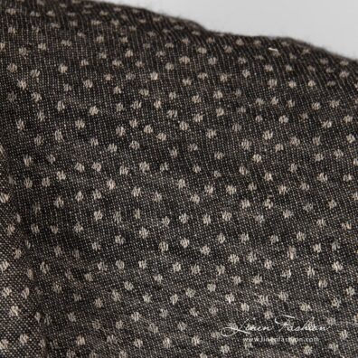 Linen-wool black fabric in dots.