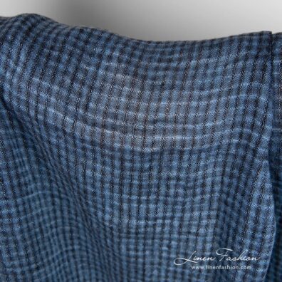 Linen fabric in transparent checks, woven from blue and black yarns