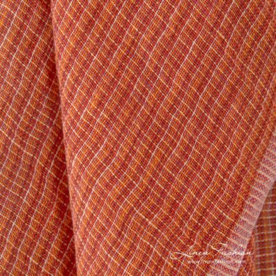 Transparent linen fabric in orange melange, perfect for curtains, shawls