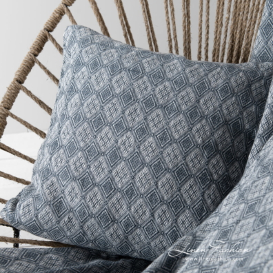 linen blanket with rhombus and decorative cushion cover.