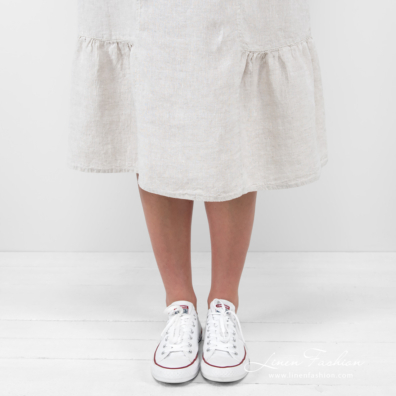 beige long linen dress with ruffles at bottom.