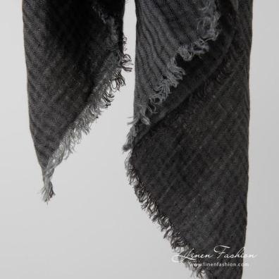 grey linen scarf with loose fringes around.