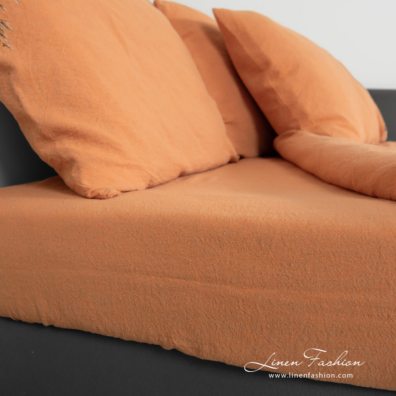 linen cotton orange bedlinen with fitted and flat sheets.
