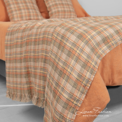 linen cotton orange bedlinen with checked throw.