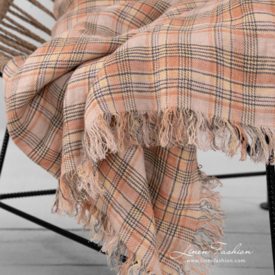 checked linen throw, with loose fringes.