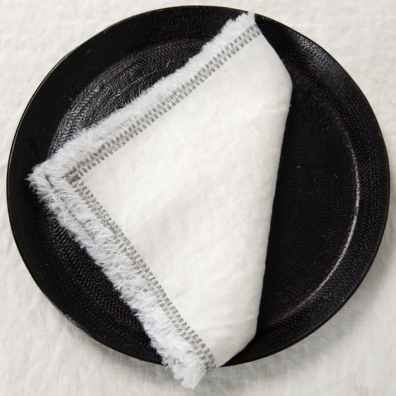 white linen napkin with decorative stitch.