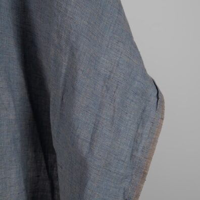 Linen Fabric Brownish Blue Color Washed for sewing clothes and home textiles close up edge view
