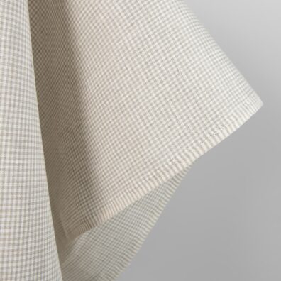 Linen fabric in natural and white colour checks close up edge view