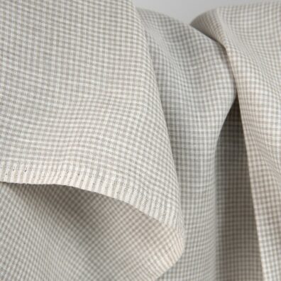 Linen fabric in natural and white colour checks close up detail view