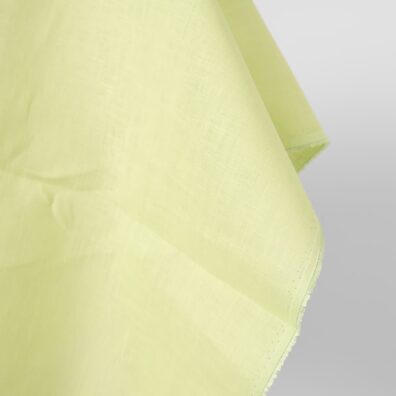 Linen fabric light greenish yellow colour close up egde view