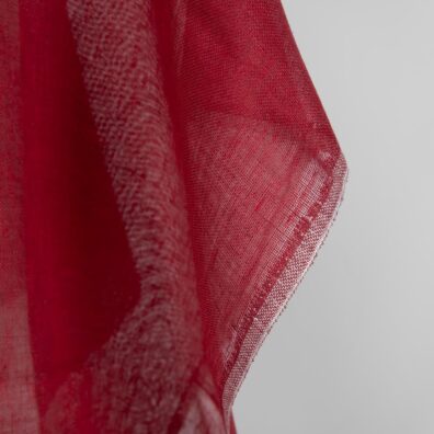 Linen fabric deep red colour transparent close up edge view
