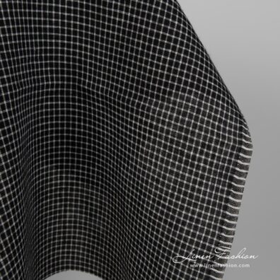 Black linen fabric with white checks close up edge view