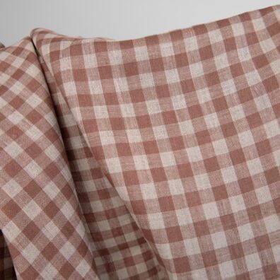 Linen fabric in brown and natural linen colour checks close up detail