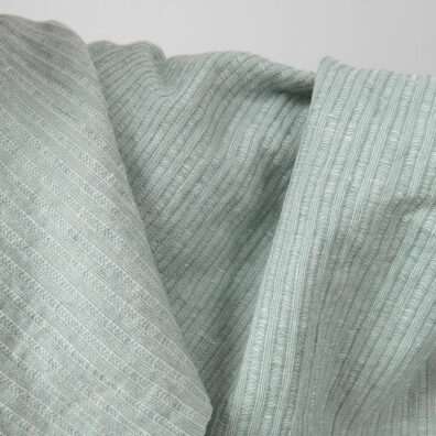 Washed linen cotton fabric greenish white colour striped close up detail