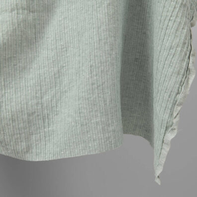 Washed linen cotton fabric greenish white colour striped close up edge
