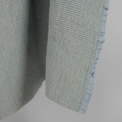 Washed linen cotton fabric blueish green waffle edge view