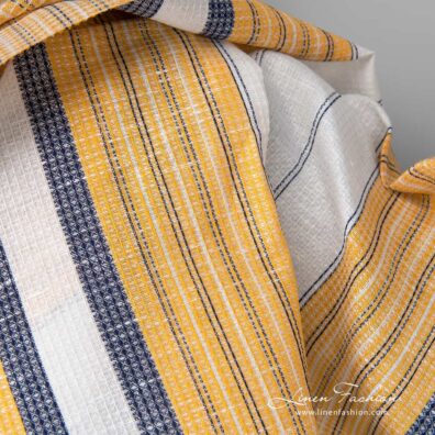 Linen cotton fabric white waffle with yellow blue stripes close up detail