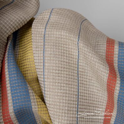 Linen cotton fabric sand waffle with yellow red stripes close up detail