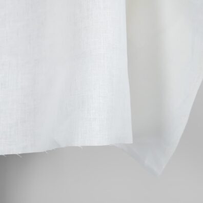 Linen fabric in plain off-white colour edge
