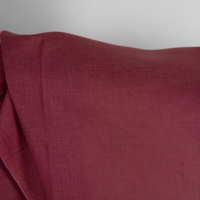 Linen fabric in dark cherry red colour close up detail