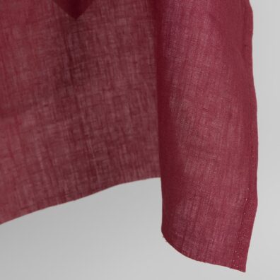 Linen fabric in dark cherry red colour edge