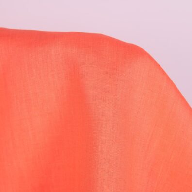 Linen fabric in living coral colour close up detail
