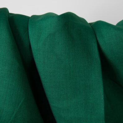 Linen fabric vibrant dark green colour close up detail