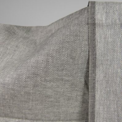 Linen fabric greyish brown in herringbone pattern front side