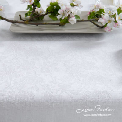 Optical white linen / cotton tablecloth decorated with intricate flower motif ornaments