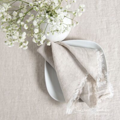 Light grey linen napkin with loose fringes