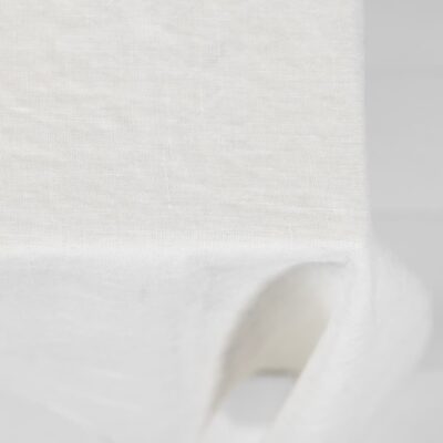 ALBA Tablecloth white 10 white linen tablecloth with decorative seam. off white background.