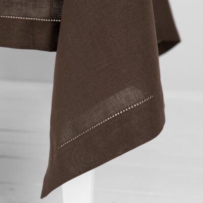 brown linen tablecloth, decorated with hemstitch.