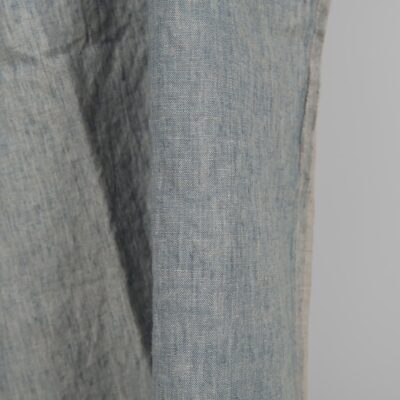 Linen washed fabric grayish blue color for sewing clothes and home textiles close edge view