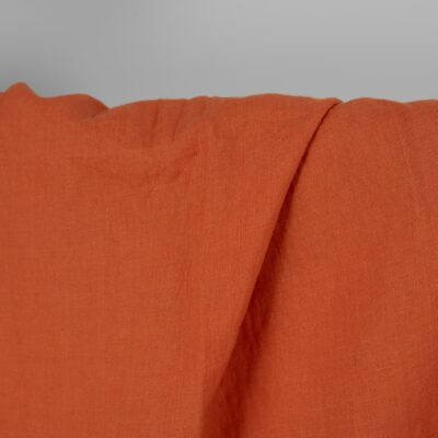 Washed linen fabric in dark orange, 100% linen