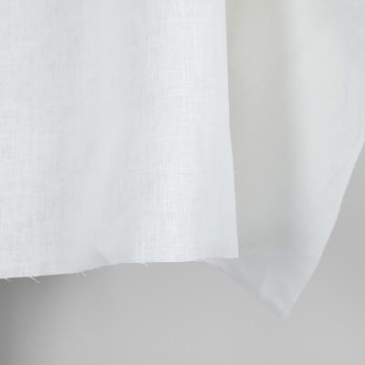 Linen fabric in plain off-white colour edge