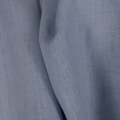 Linen fabric in plain greyish blue colour close up detail