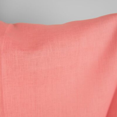 Linen fabric in geranium pink colour close up detail