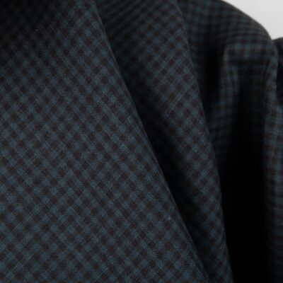 Dark linen fabric in black and blue checks close up detail view