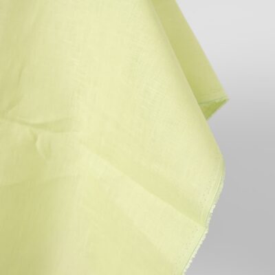 Linen fabric light greenish yellow colour close up egde view