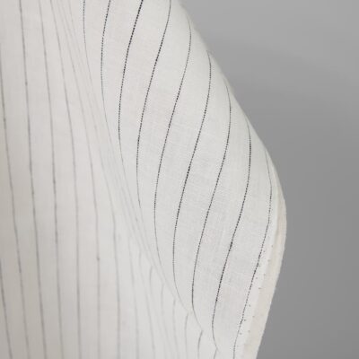 Linen fabric off-white colour with black stripes close up detail pinstripes