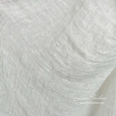 Off-white linen fabric with openwork diamonds washed