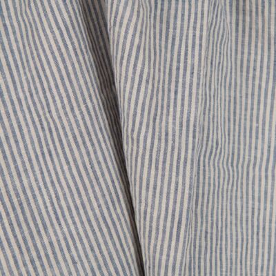 Washed linen fabric with brownish and blueish grey stripes close up view