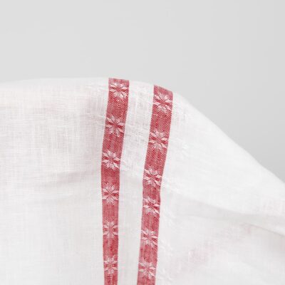 White linen fabric with red lines close up detail