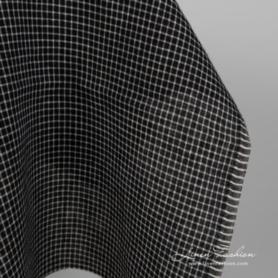 Black linen fabric with white checks close up edge view