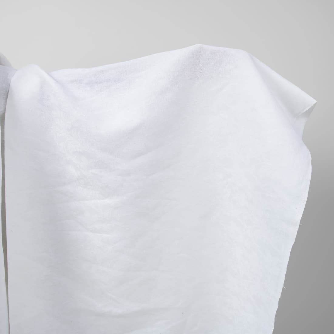 Optical white linen cotton fabric with flower ornaments