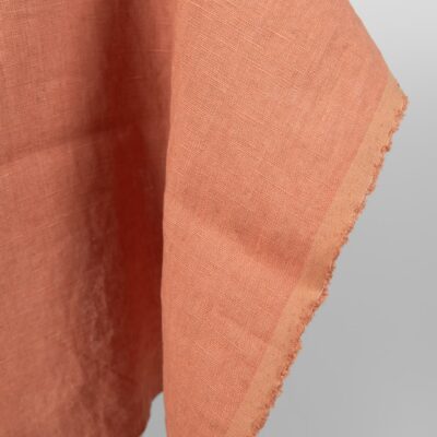 Washed linen fabric coral nude colour close edge view