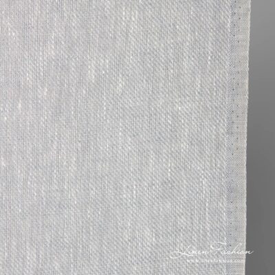 Narrow linen fabric in white-grey melange close up photo